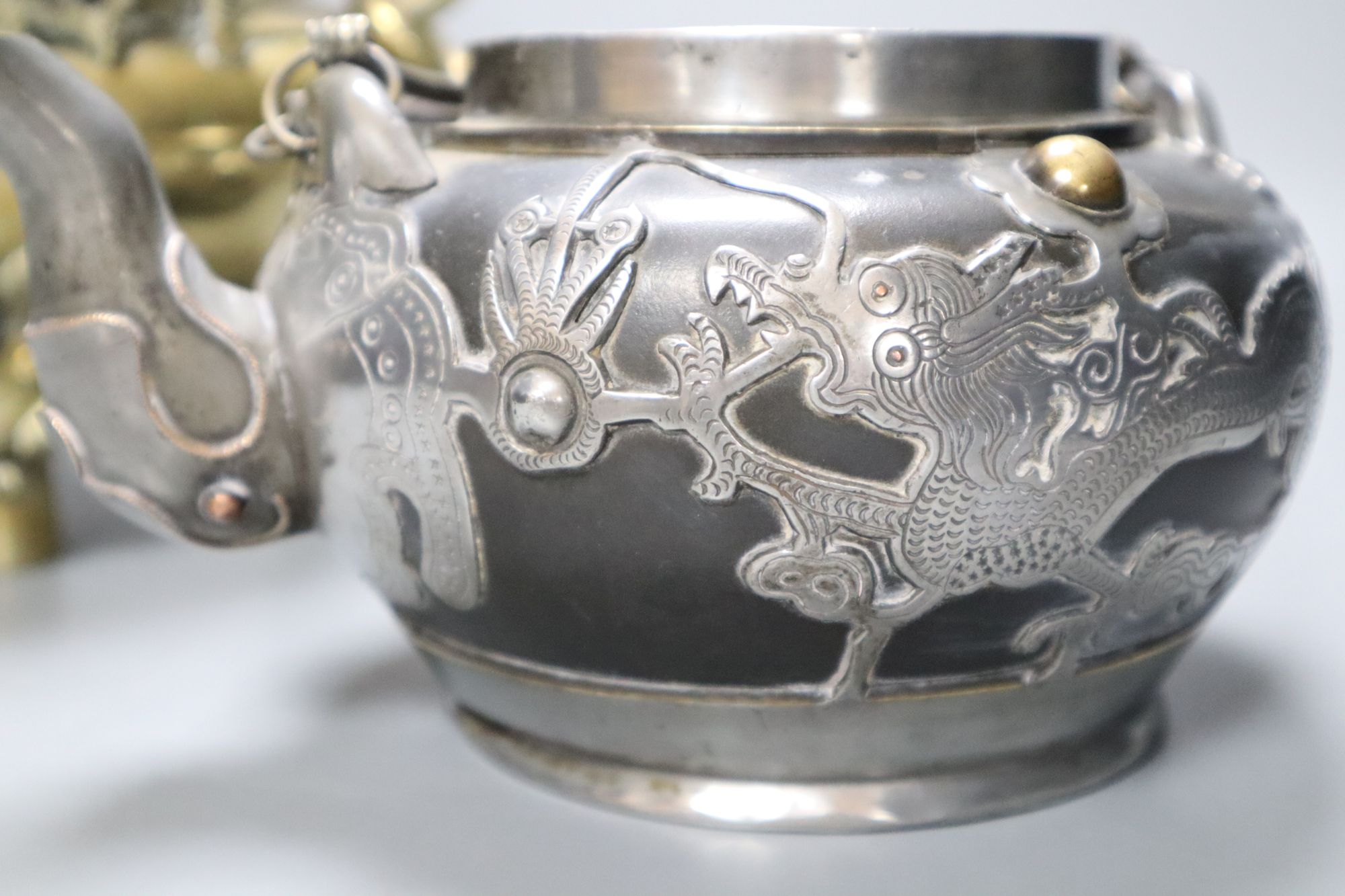 A Chinese bronze tripod censer, height 16cm, and a Chinese pewter-mounted Yixing pottery teapot, lacking lid (2)